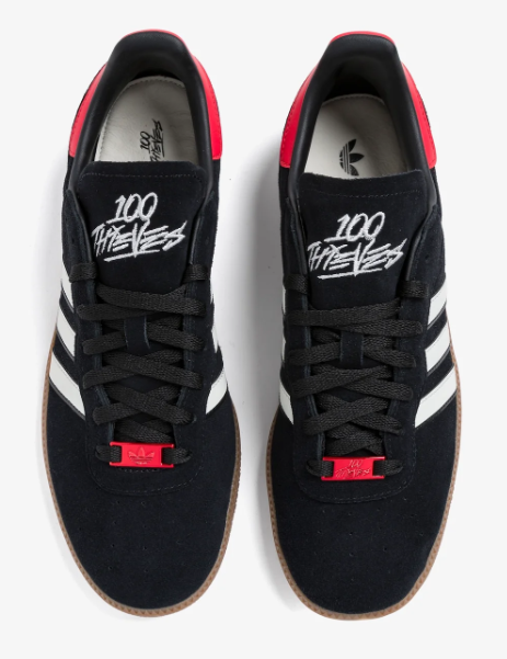 Top view of black adidas Palos Hills sneakers with 100 Thieves tongue graphics and red lace accents